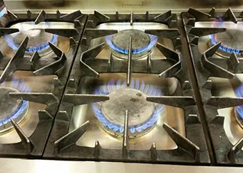 Photo of a gas range rings alight